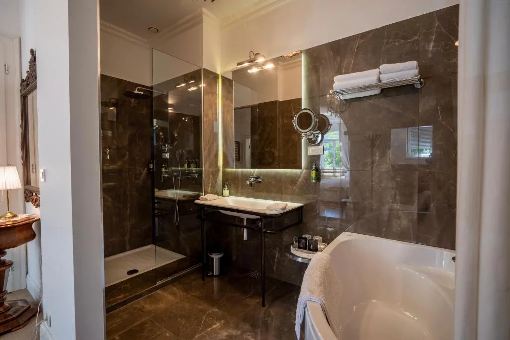 Luxury King Room bathroom with a bath and shower